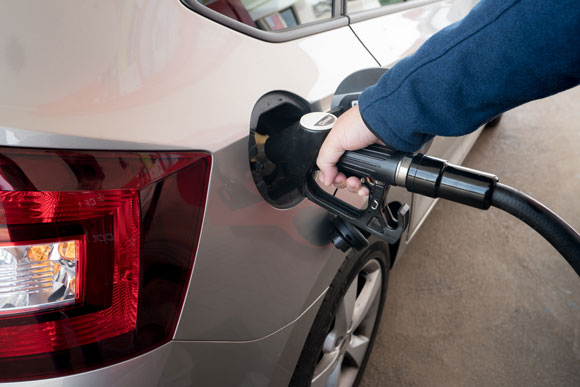 person fueling up diesel engine car