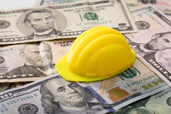 hard hat sitting on US banknotes