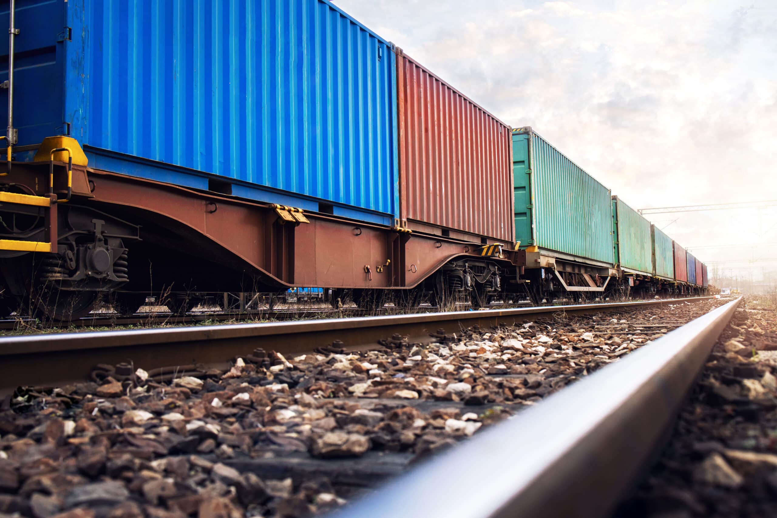 Train wagons carrying cargo containers for shipping companies. D