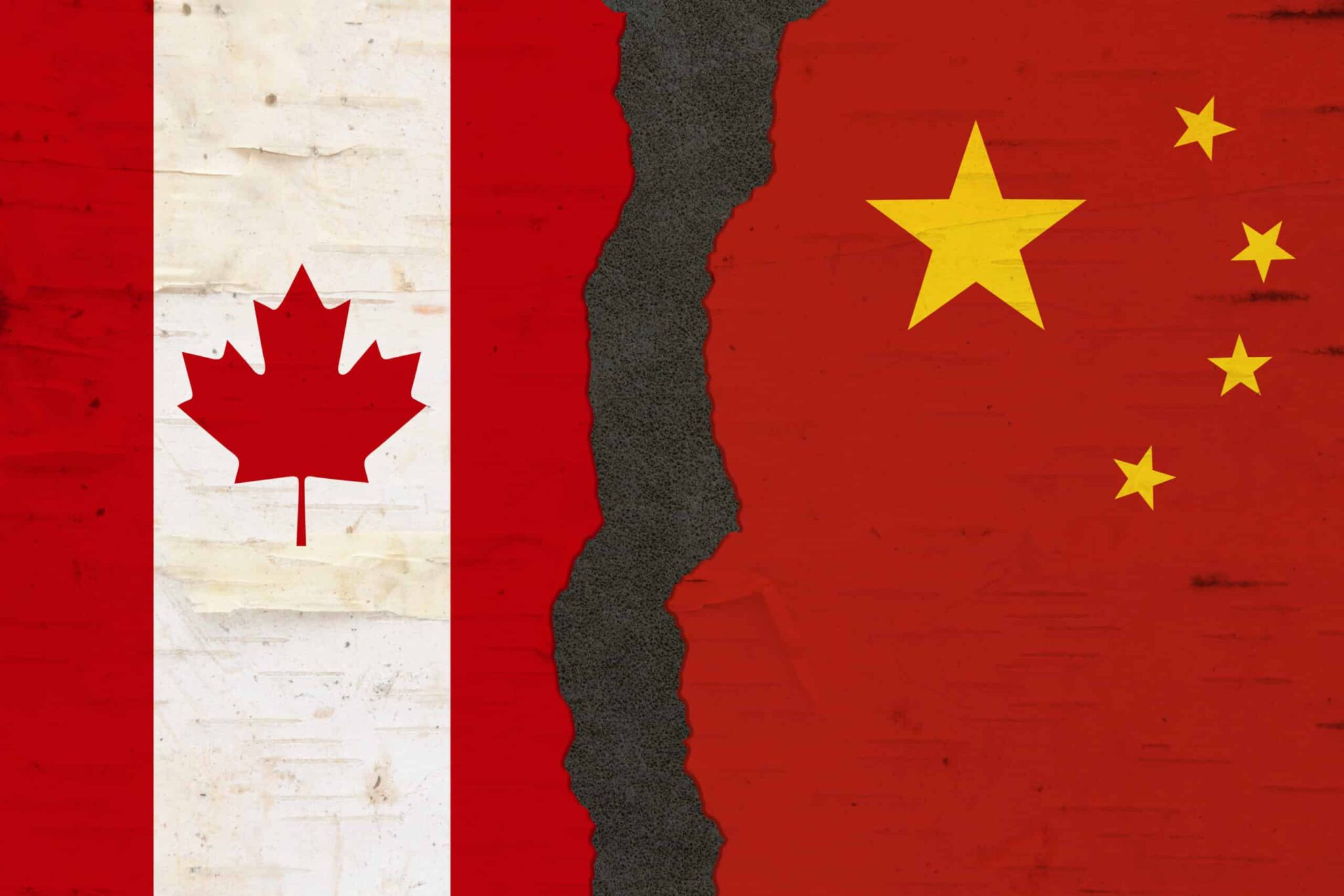 Canadian and Chinese flags that are torn apart