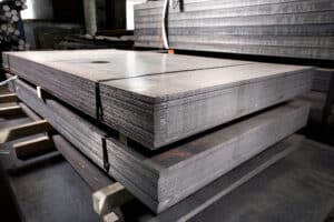 Stainless steel bars and pipes deposited in stacks