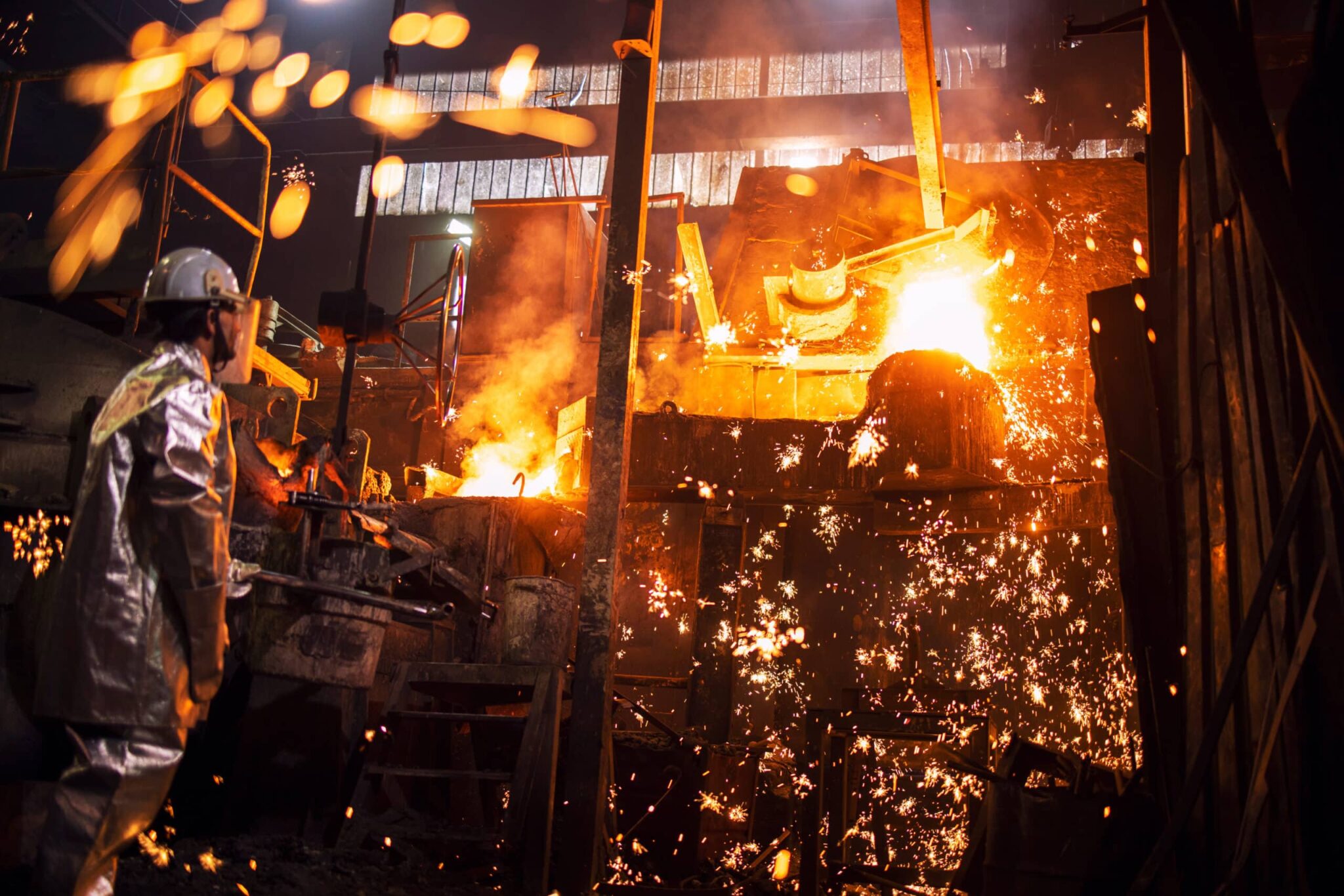 foundry-worker-controlling-process-of-melting-iron-in-furnace-b