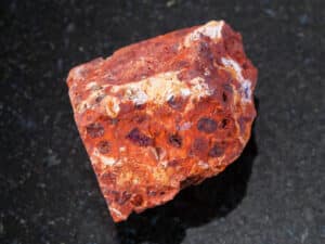 rough red bauxite stone on dark background